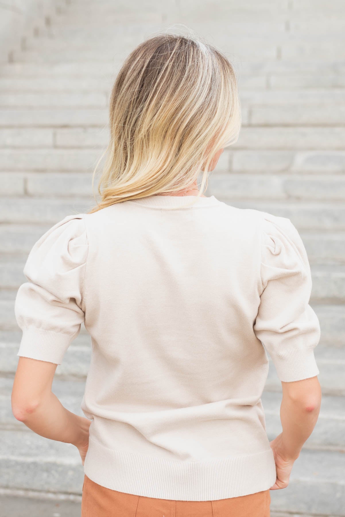 Back view of the beige puff sleeve sweater top