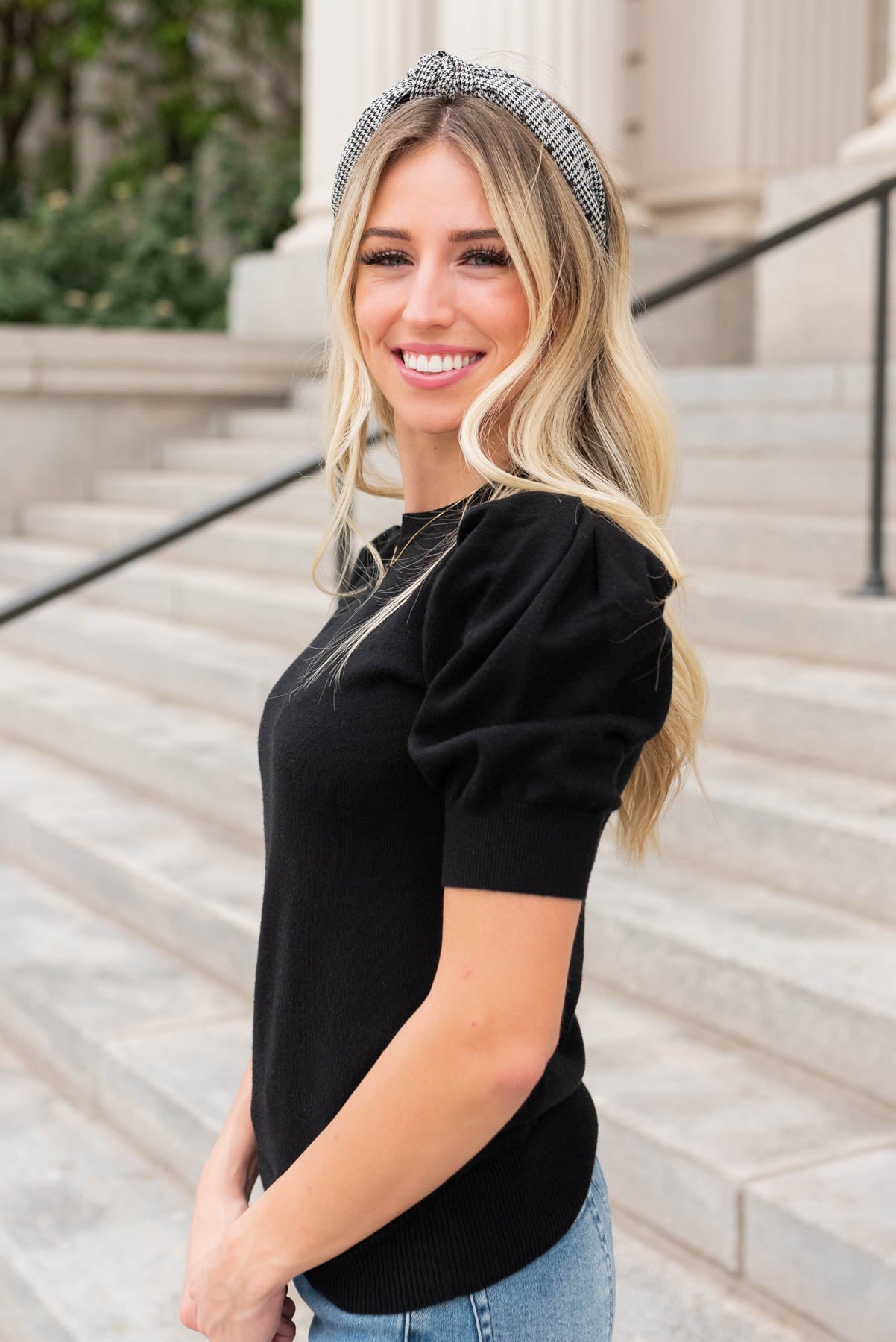 Side view of the black puff sleeve sweater top