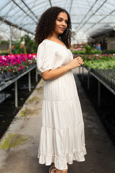 Side view of the ivory satin tiered dress