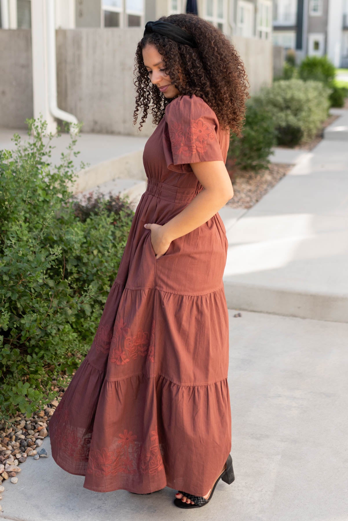 Side view of the burgundy embroidered detail dress with pockets