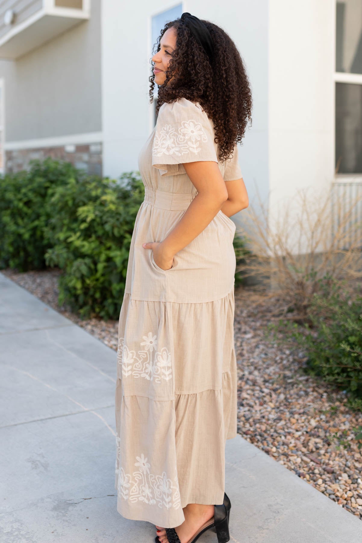 Side view of the taupe embroidered detail dress