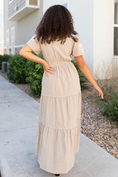 Back view of the taupe embroidered detail dress