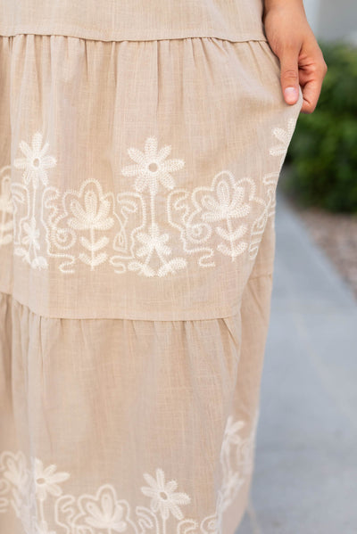 Close up on the embroidery on the taupe embroidered detail dress