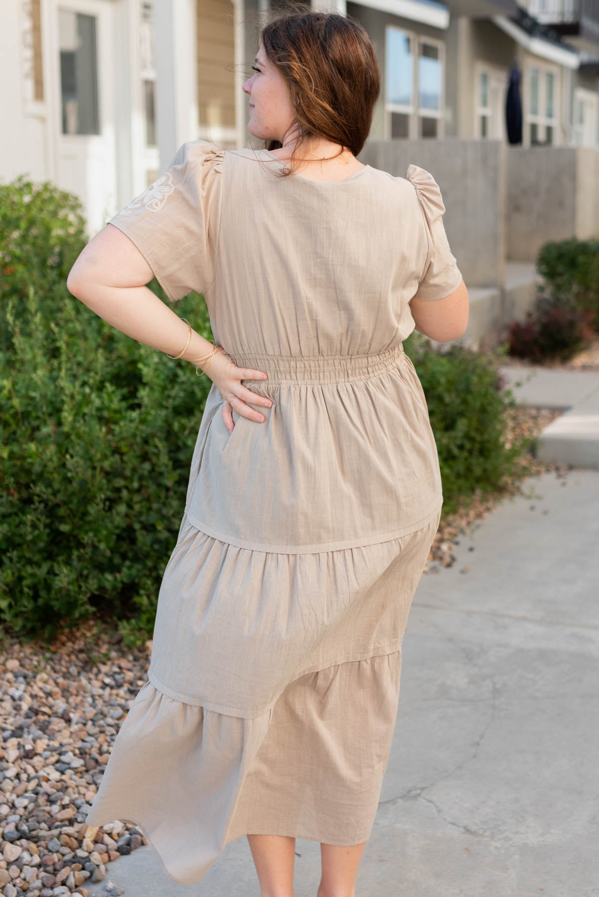 Back view of the taupe embroidered detail dress in plus szie