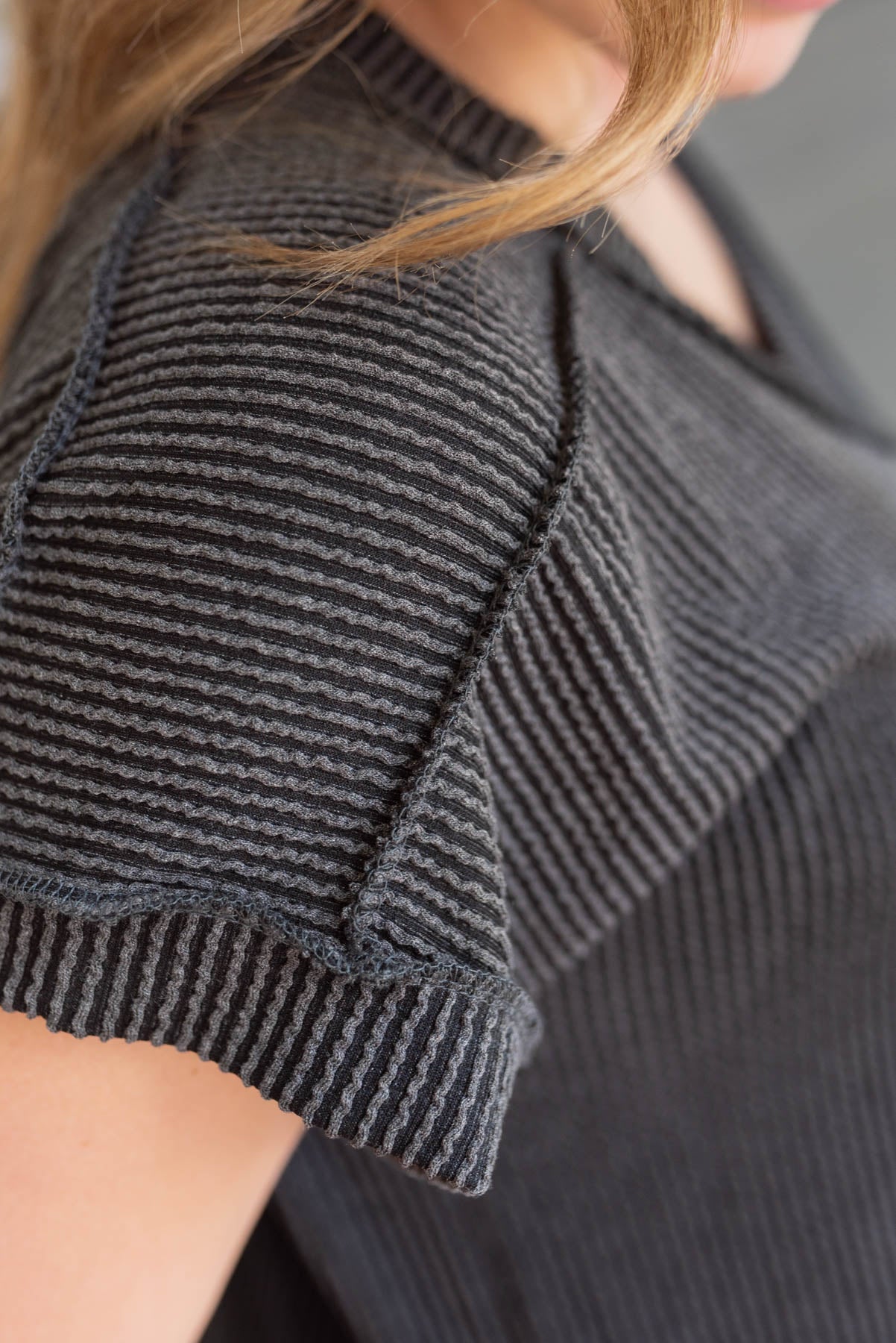 Close up of the sleeve and fabric on the charcoal ribbed t-shirt dress