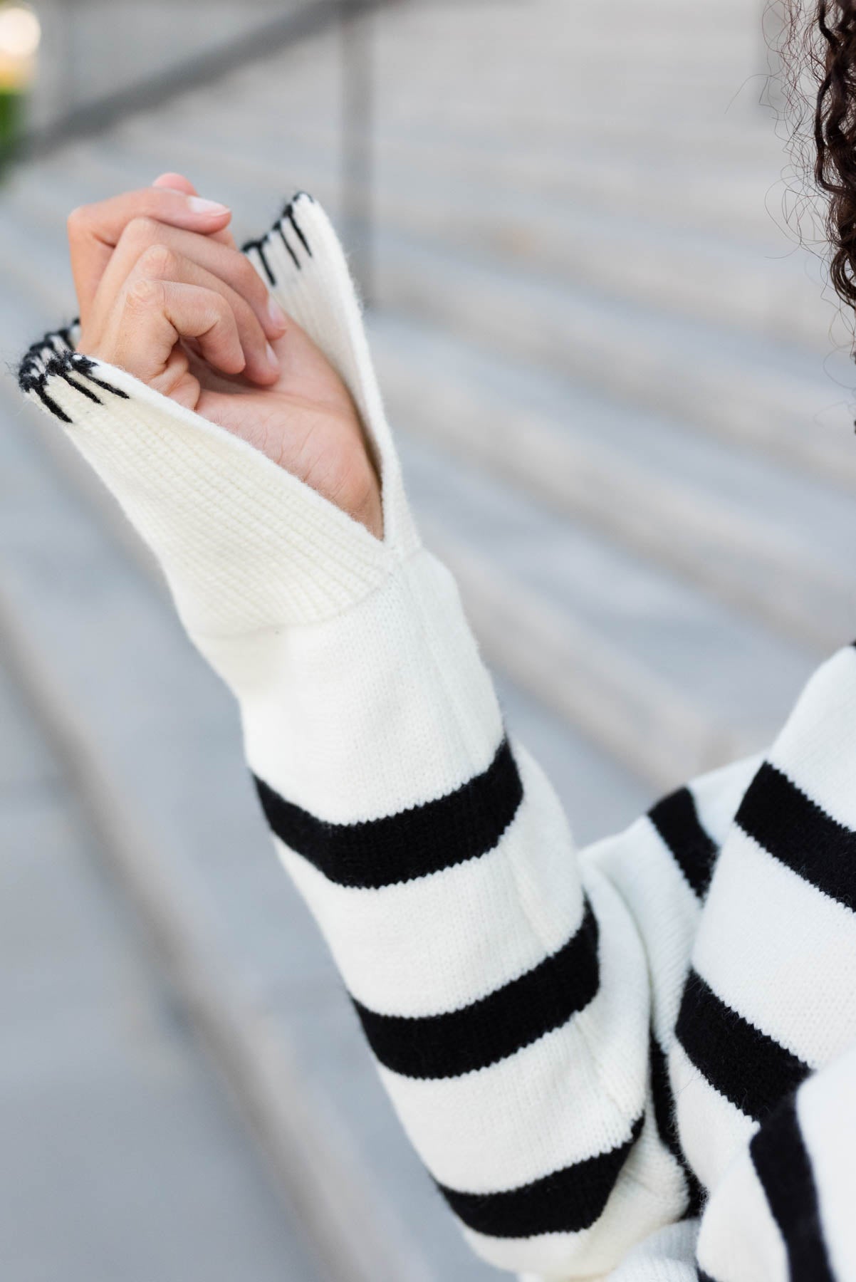 Close up of the cuff on the ivory black stripe sweater