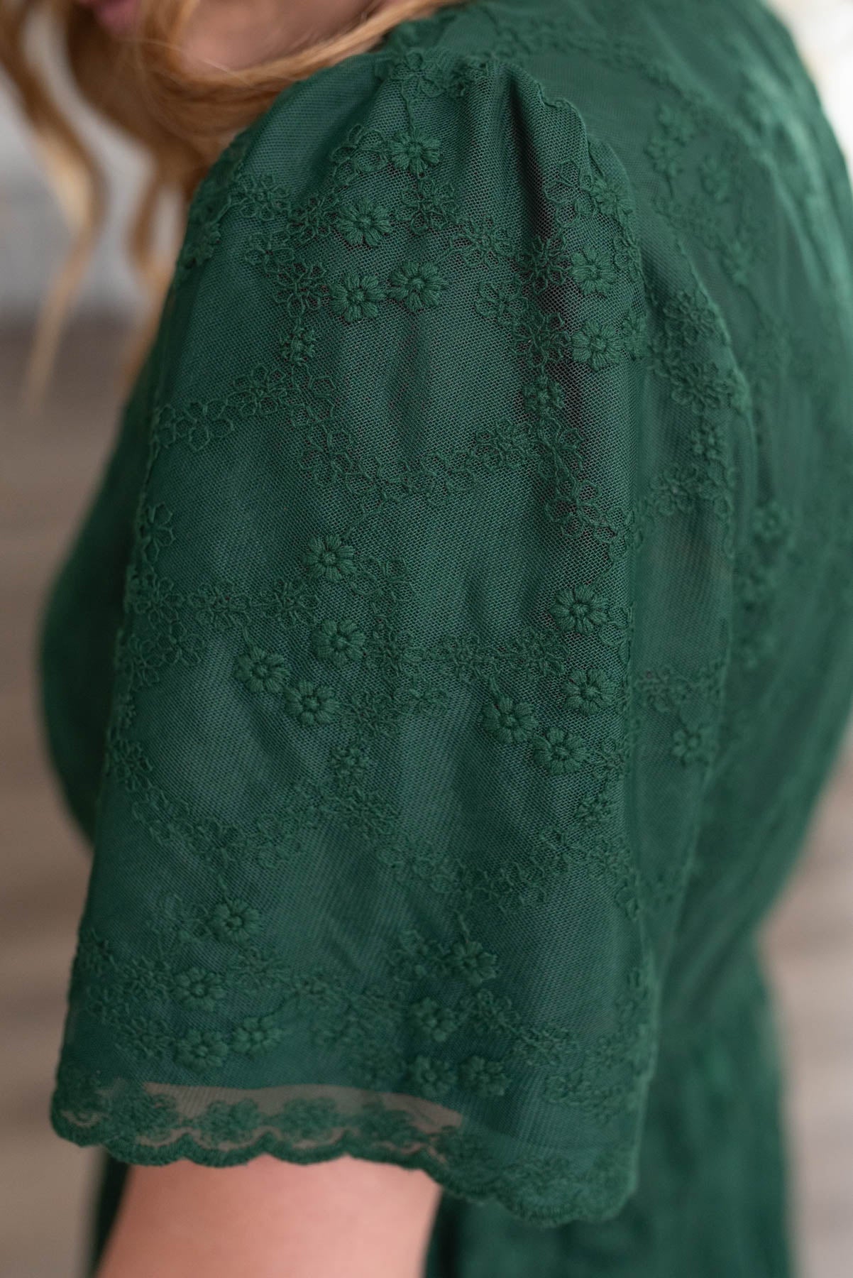 Close up of the sleeve and lace on the hunter green lace floral dress