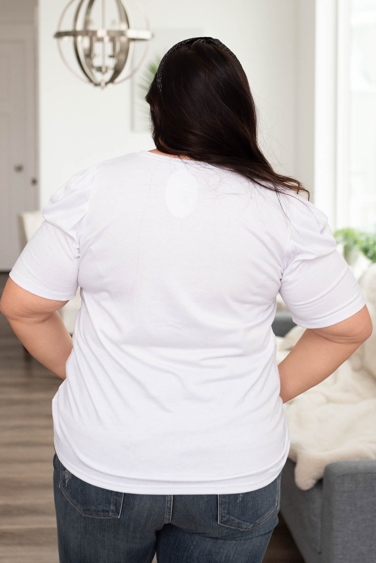 Back view of a plus size white v-neck puff sleeve top