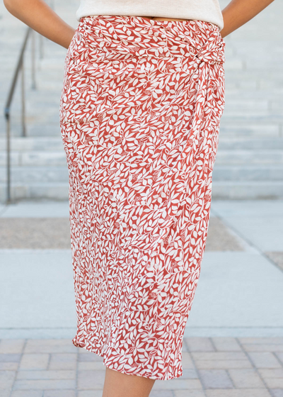 Rust floral knit skirt that falls right blow the knees