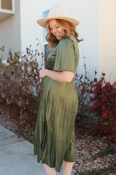 Side view of the olive pleated velvet dress