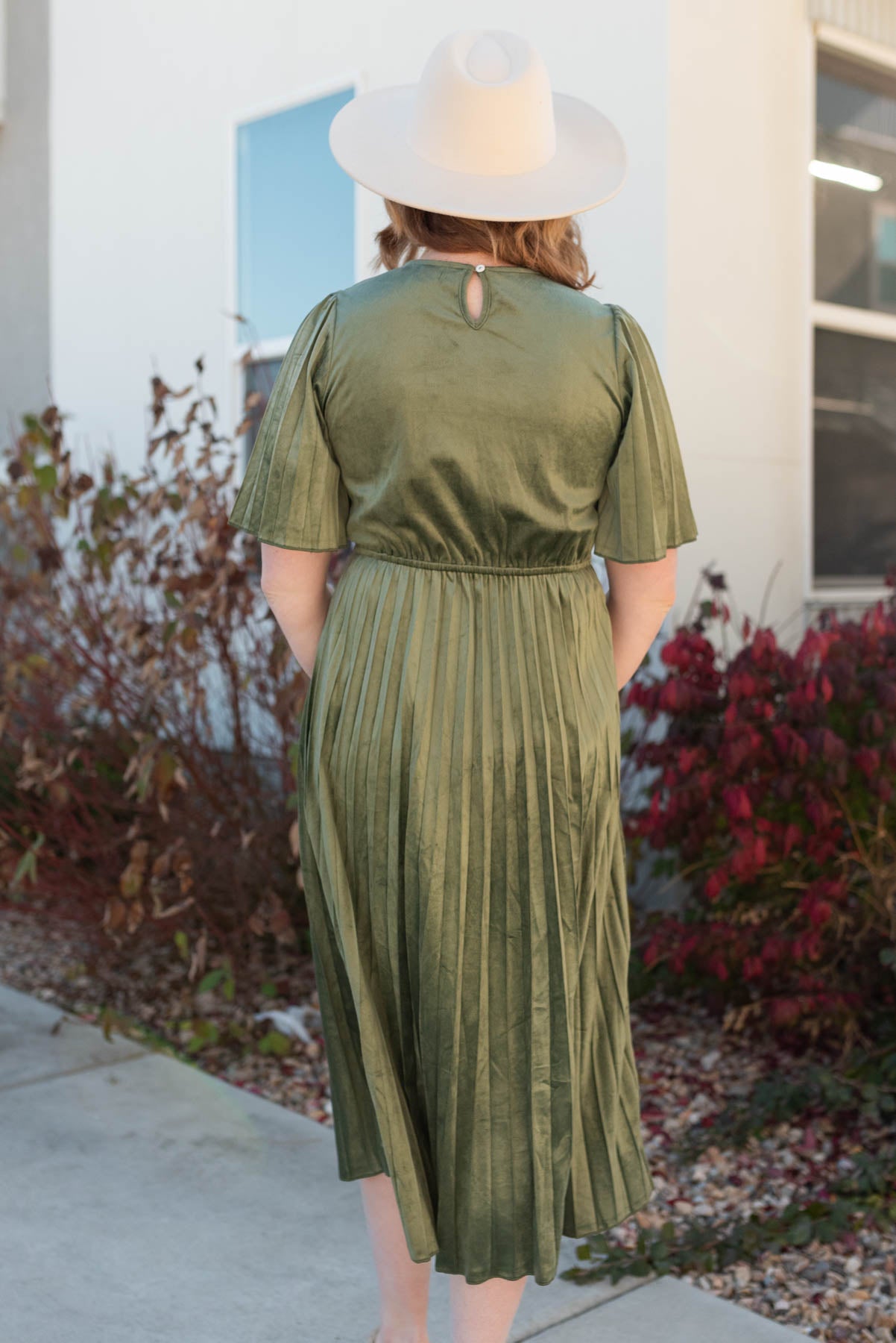 Back view of the olive pleated velvet dress