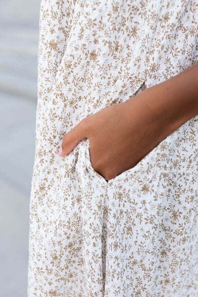 Close up of the pocket and fabric on the taupe floral button dress