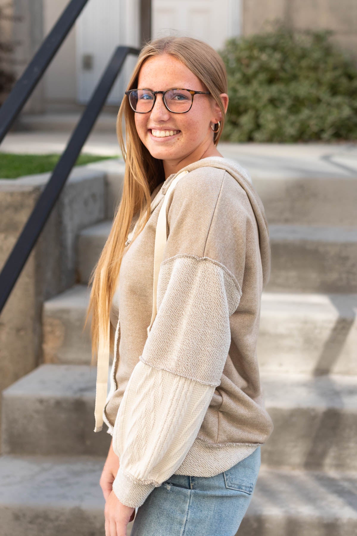 Side view of a taupe hoodie