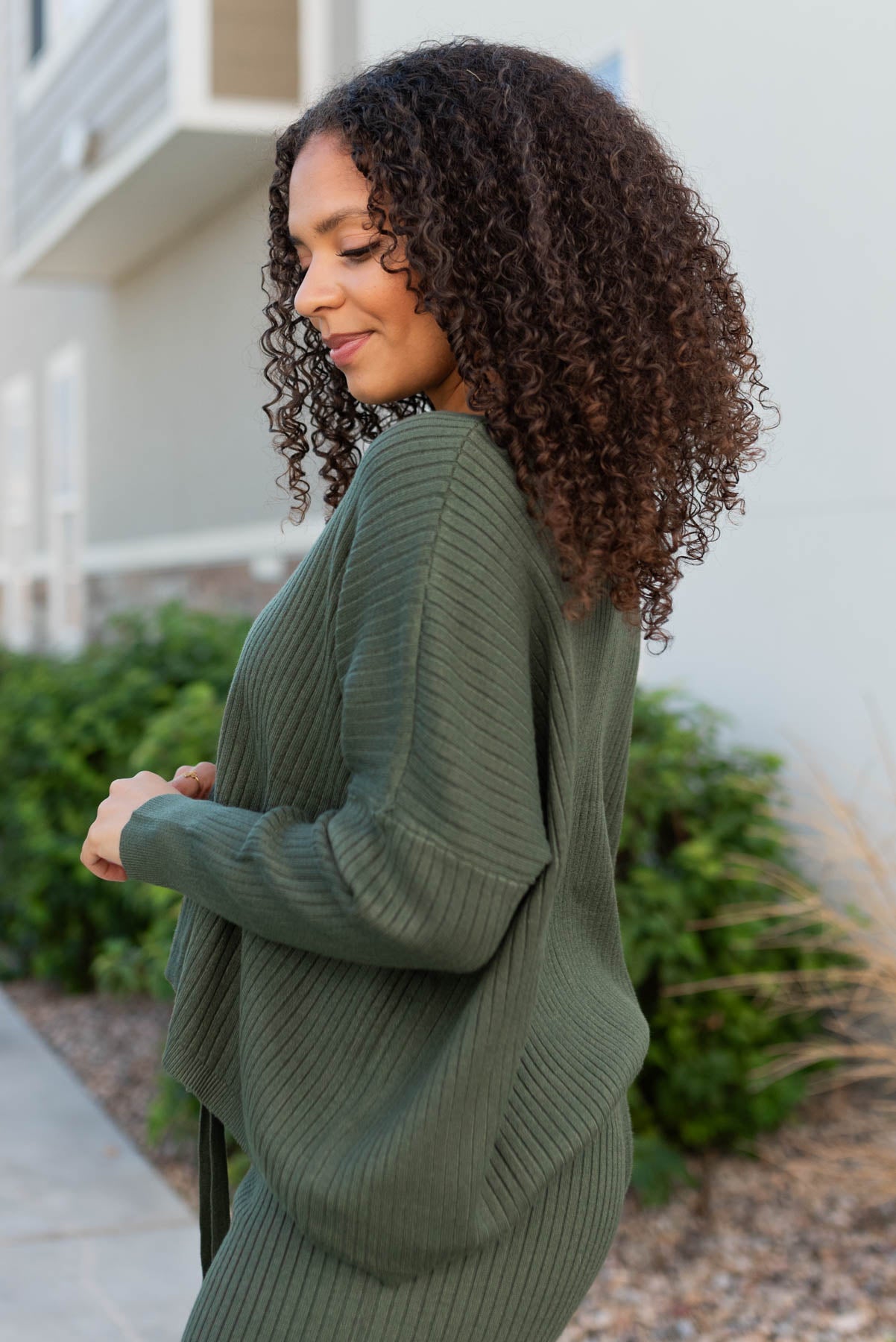 Side view of the dark green sweater