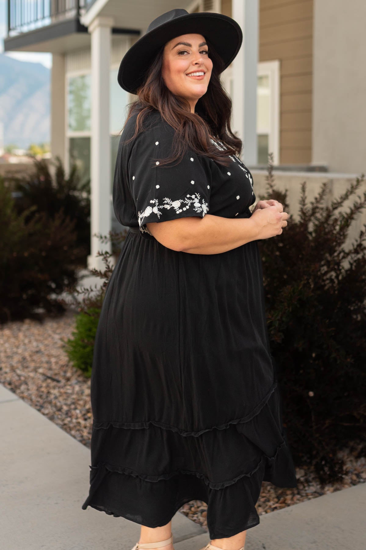 Side view of a plus size black floral dress