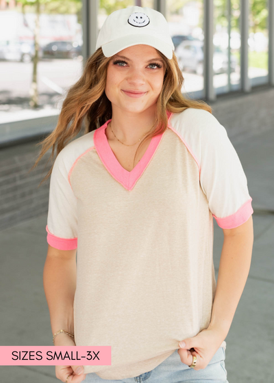 Taupe pink color block top with pink trim at the neck and cuffs