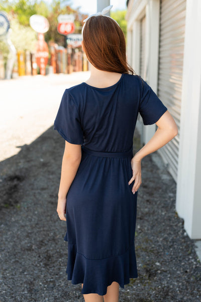 Back view of the navy ruffle tie dress