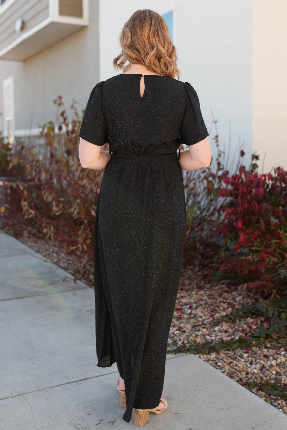 Back view of a black sparkle maxi wrap dress