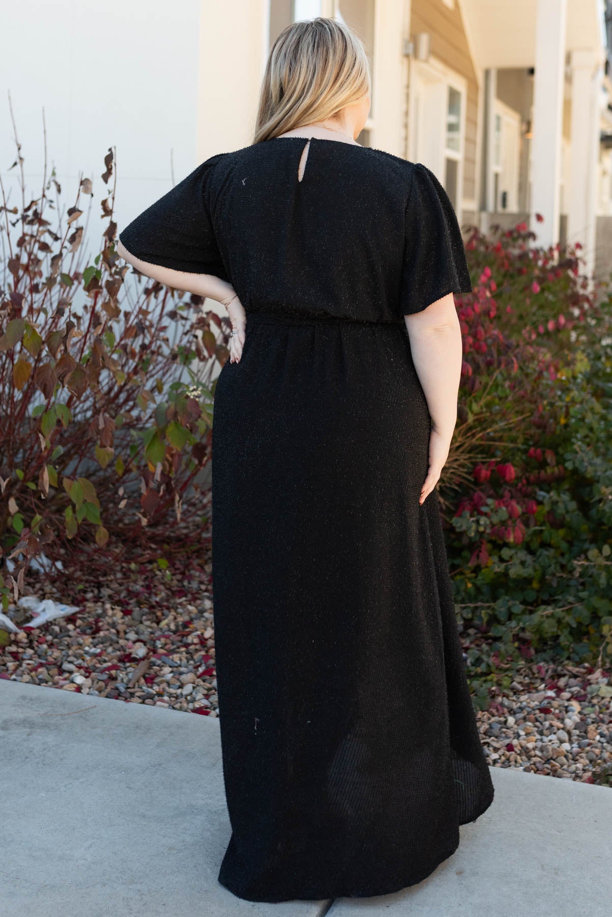 Back vie of the plus size sparkle maxi wrap dress