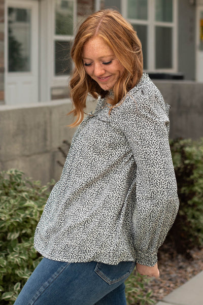 Side view of a cream black print top