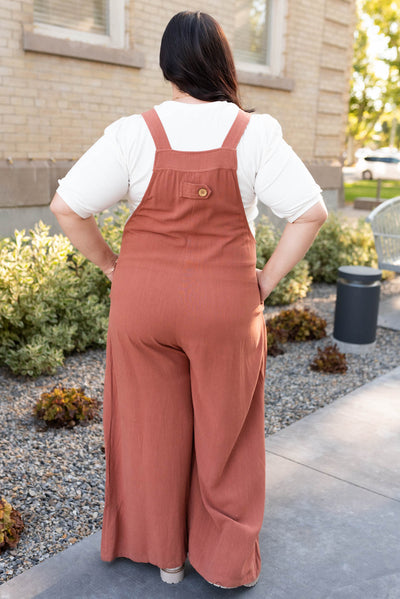 Back view of the rust wide leg overalls