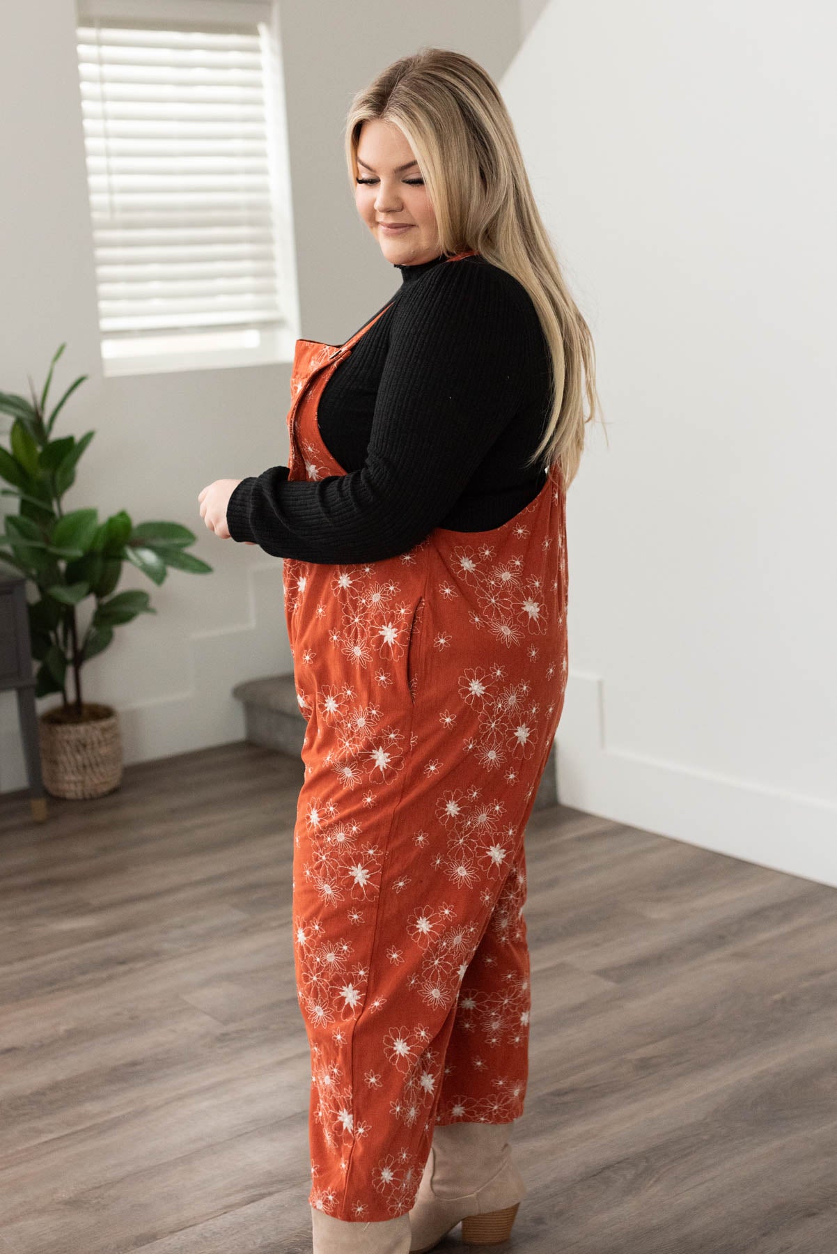 Side view of rust embroidered overalls