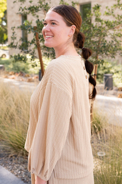 Side view of the beige textured top