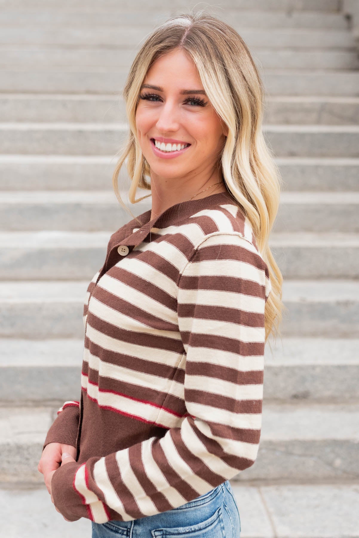 Side view of the brown button down sweater