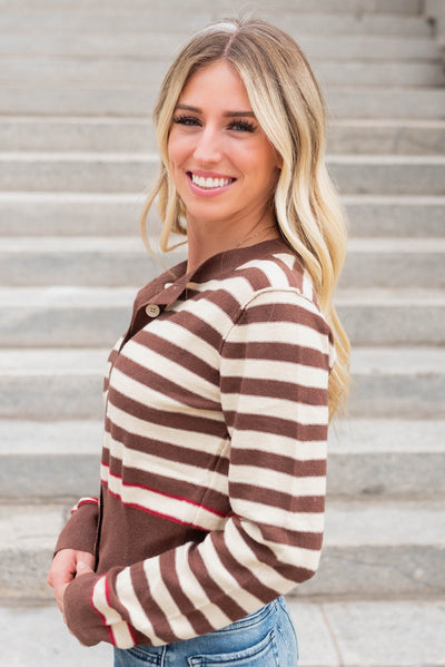 Side view of the brown button down sweater