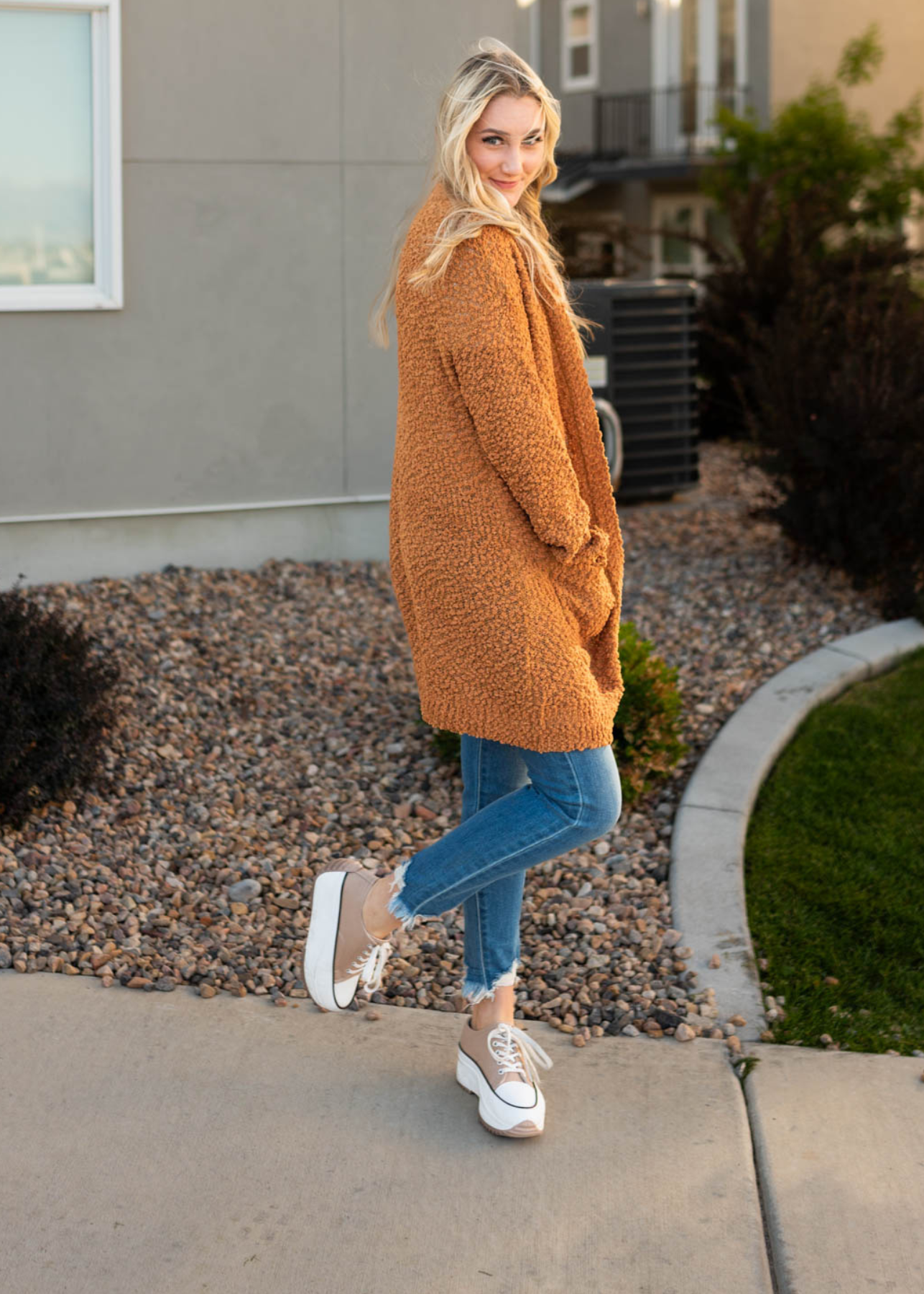 Side view of a dark mustard popcorn cardigan