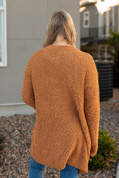 Back view of a dark mustard popcorn cardigan