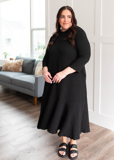 Plus size black textured ruffle hem dress