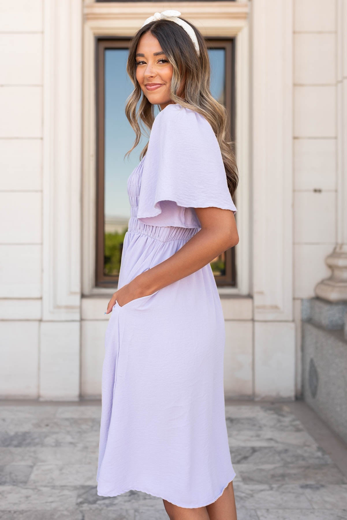 side view of the dusty purple midi dress with pockets