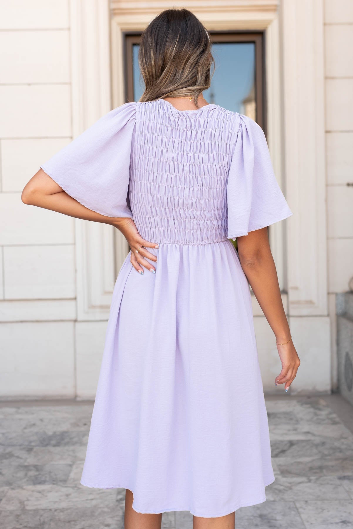 Back view of the dusty purple midi dress