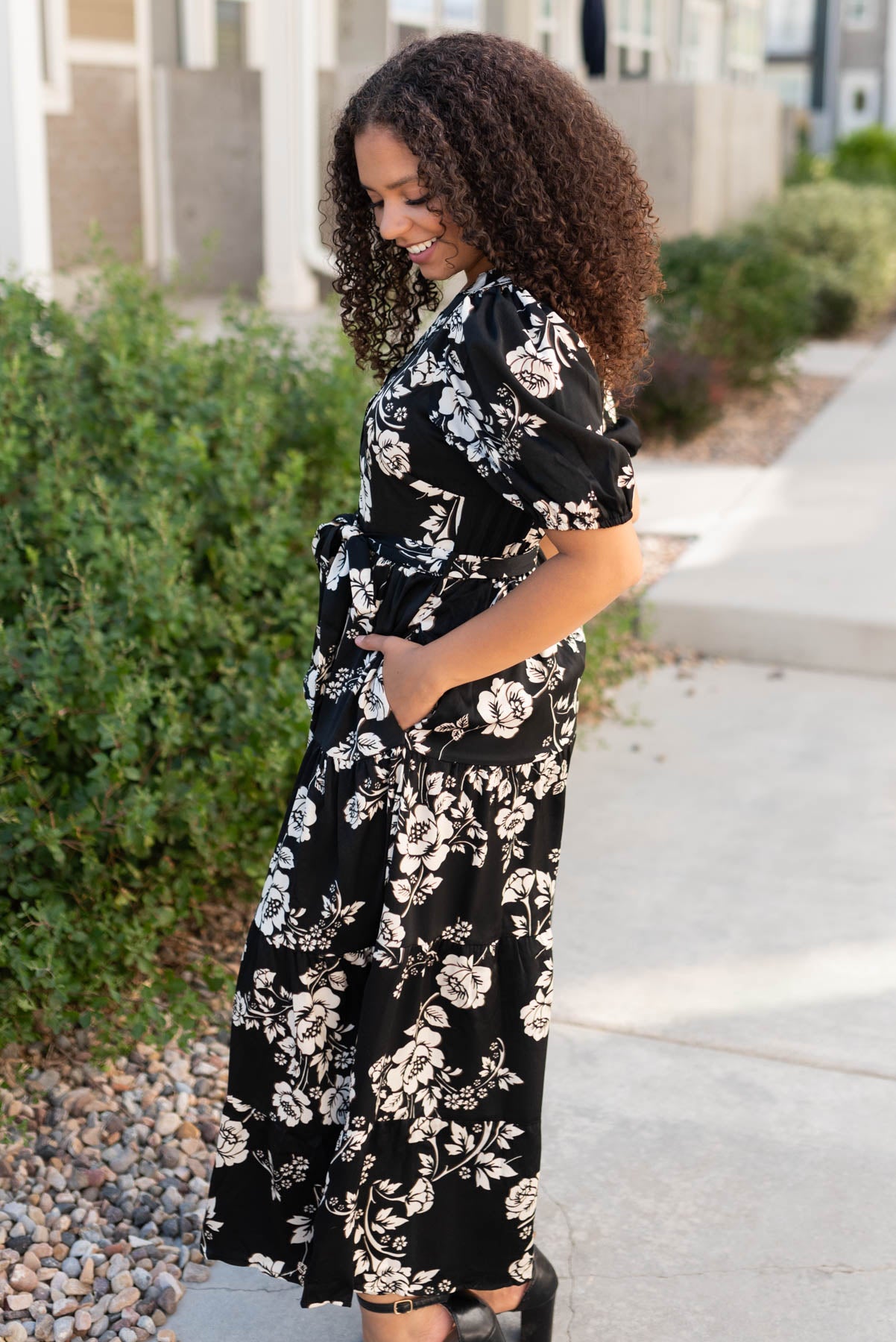 Side view of the black floral button tiered dress