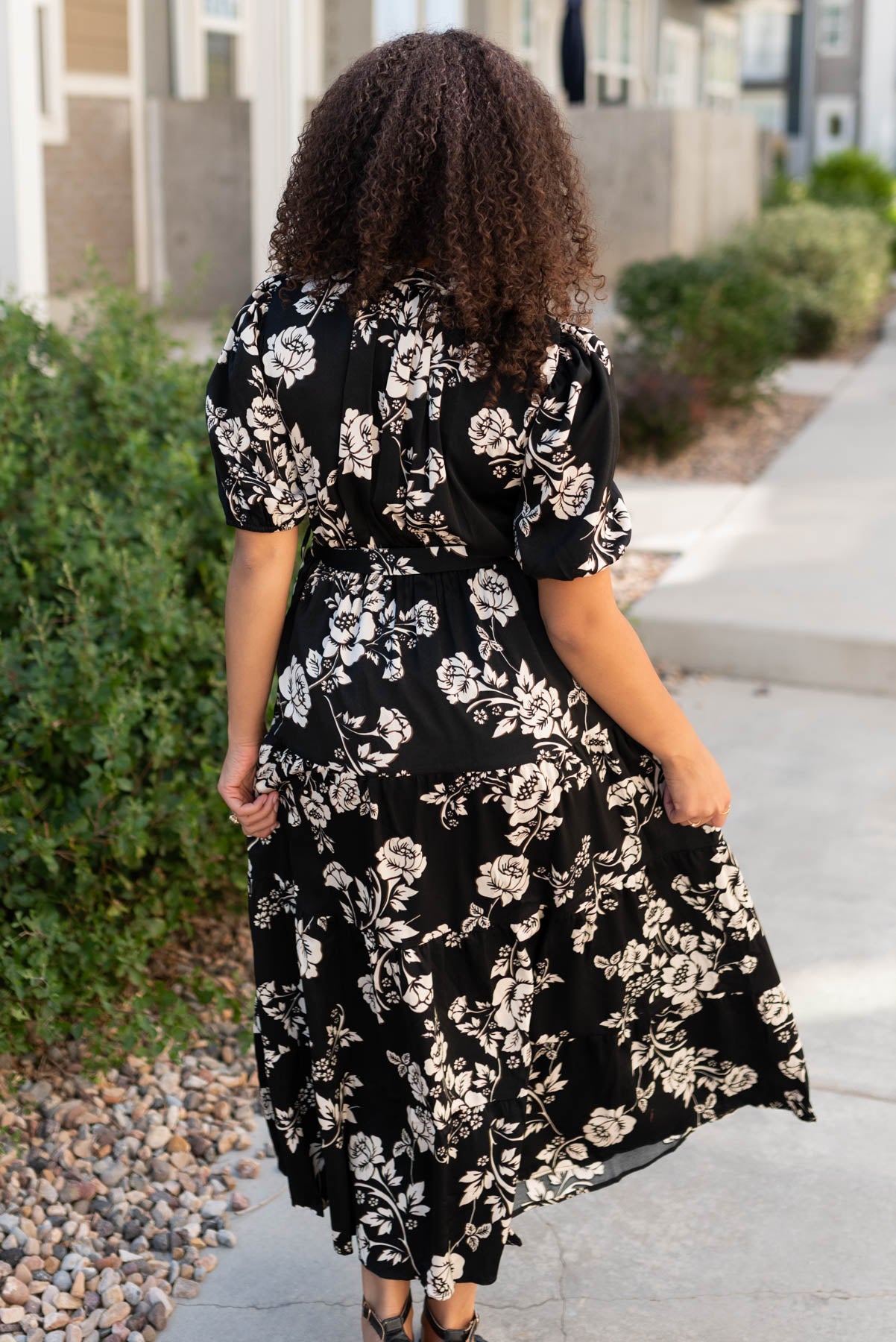 Back view of the black floral button tiered dress