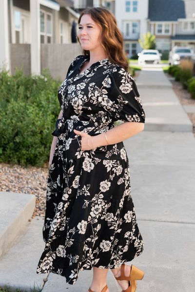 Side view of the plus size black floral button tiered dress with pockets