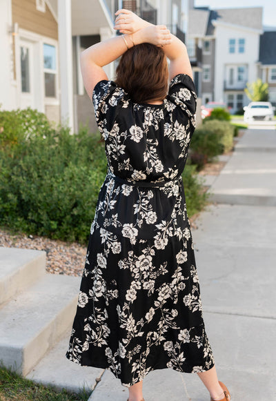 Back view of the plus size black floral button tiered dress