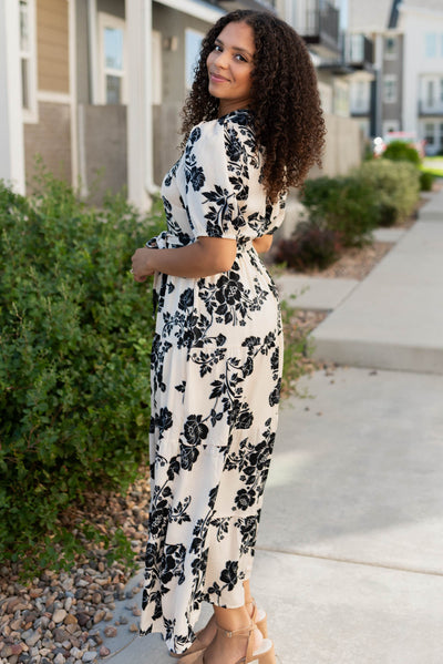 Side view of the cream floral button tiered dress