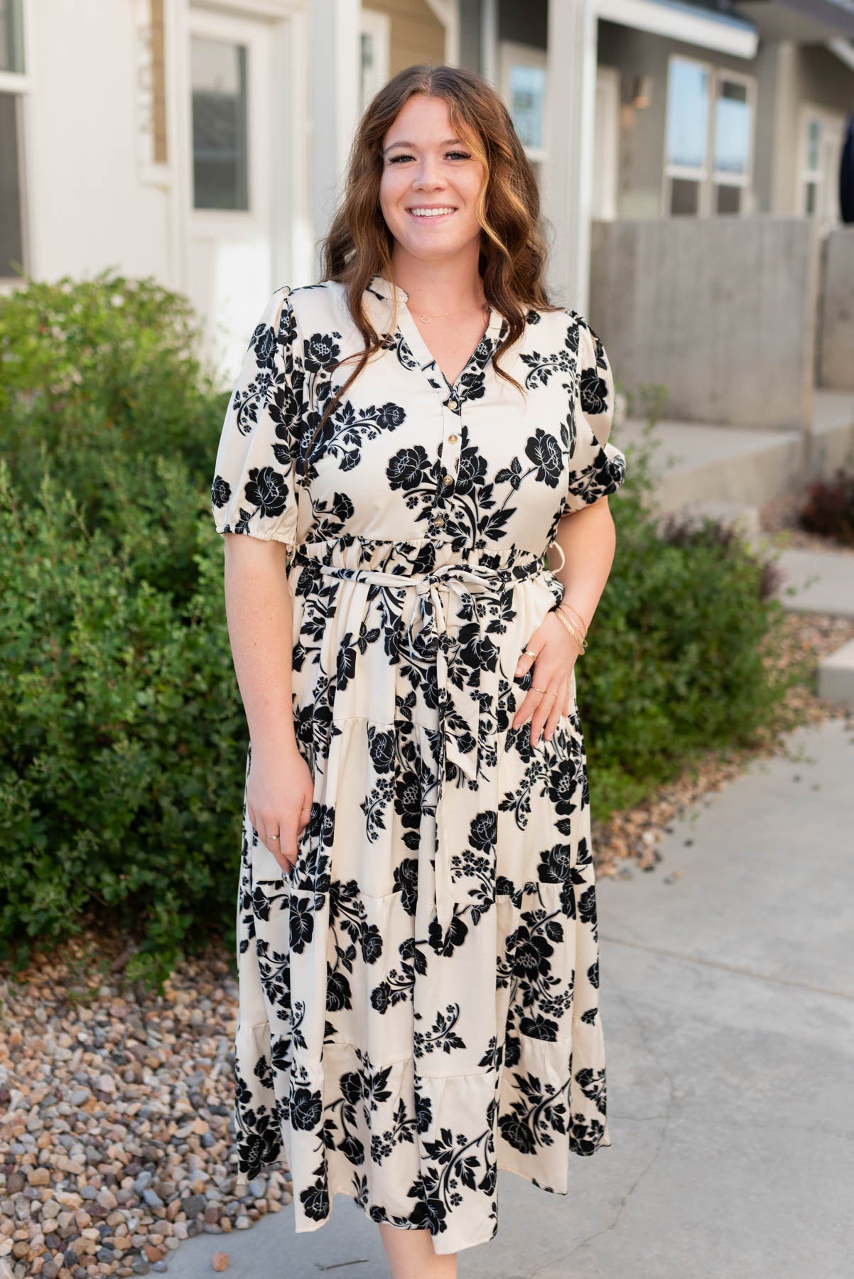 Black flowers on the cream floral button tiered dress in plus size