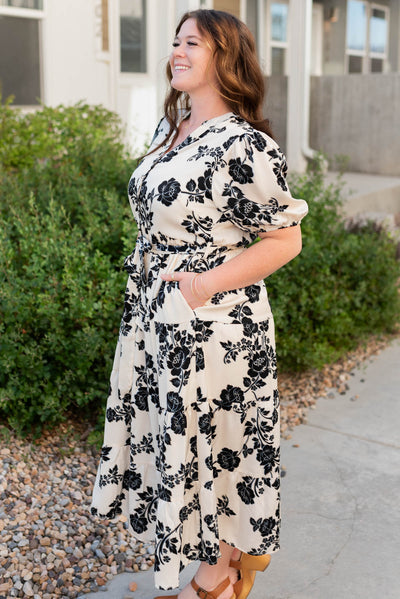 Side view of the cream floral button tiered dress with pocket in plus size