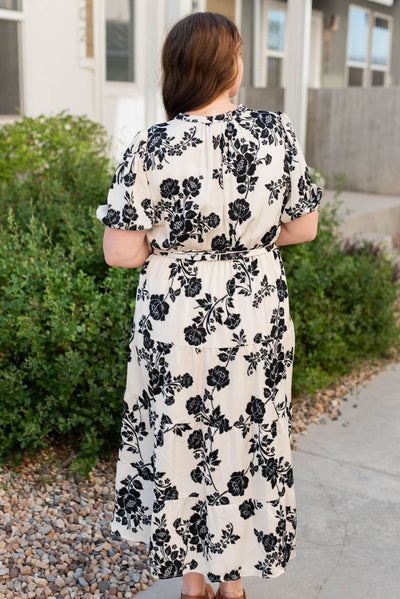 Back view of the cream floral button tiered dress in plus size