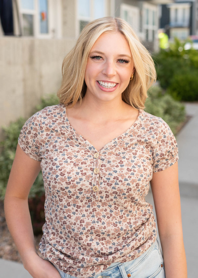 Ivory floral tip with buttons at the neckline