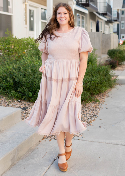 Plus size blush dress with lace trim on the tiered skirt