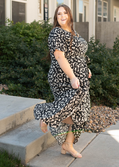 Side view of a plus size black floral dress