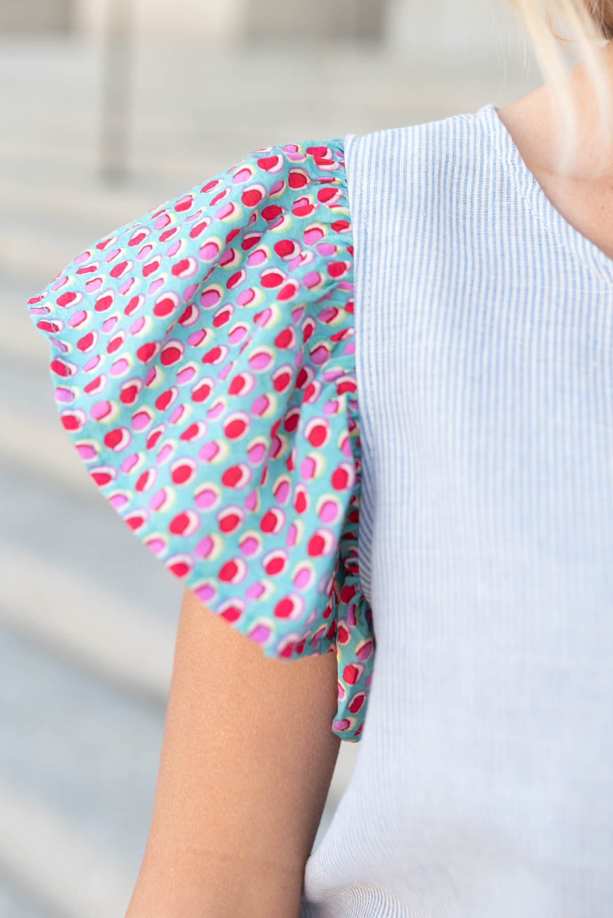 Close up of the sleeve on the blue stripe pattern top