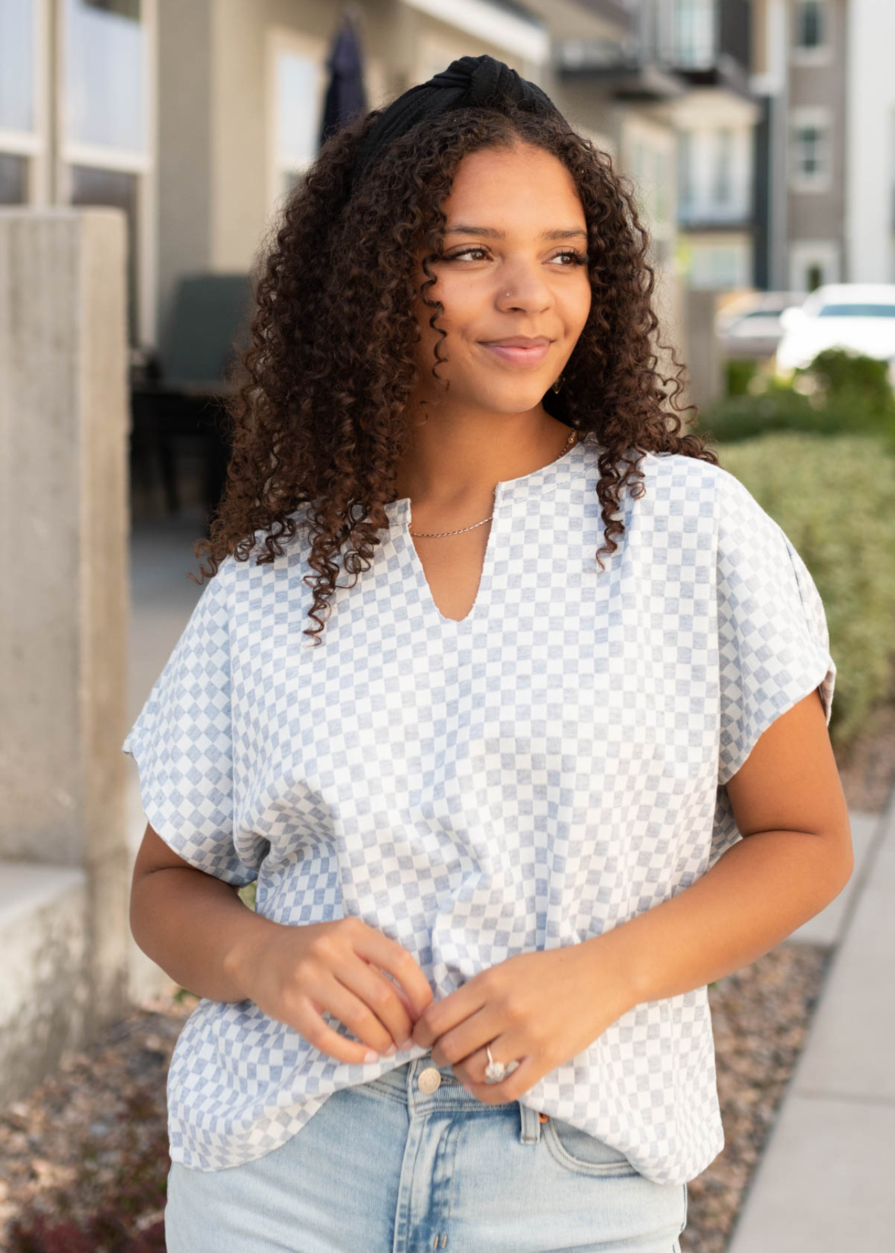 V-cut in the neck on the heather grey checkered top