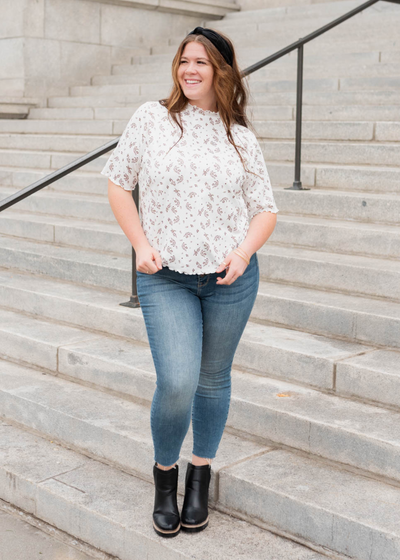 Ivory floral top with short sleeves to the elbow