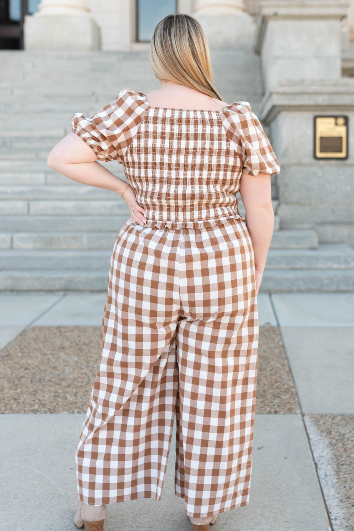 Back view of the plus size taupe gingham jumpsuit