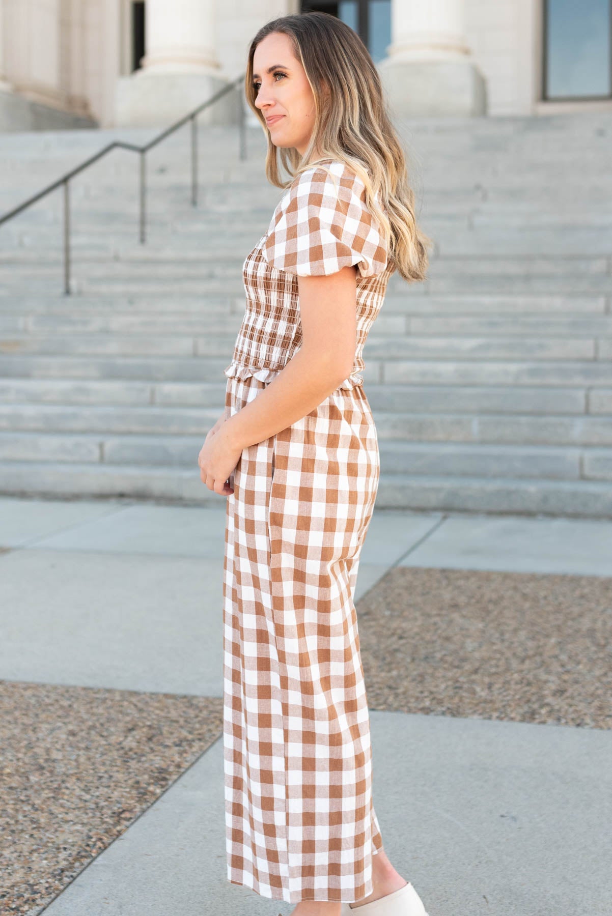 Side view of the taupe gingham jumpsuit